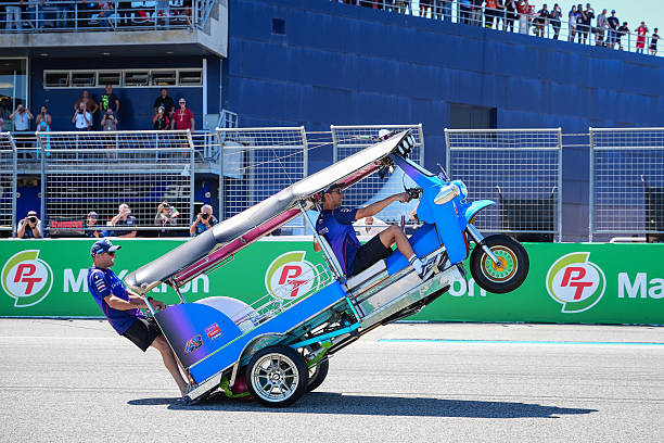 BURIRAM, THAILAND - 01/03/2026: Pembalap Jack Miller dan Toprak Razgatlioglu mengendarai tuk-tuk tradisional Thailand selama perlombaan parade pengemudi tuk-tuk di PT Grand Prix Thailand 2026. (Foto oleh Amphol Thongmueangluang/SOPA Images/LightRocket via Getty Images)